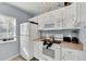 White kitchen features stainless steel appliances and light countertops at 2203 San Vittorino Cir # 102, Kissimmee, FL 34741