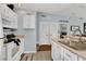 Kitchen features white cabinets, stainless steel appliances, and light countertops at 2203 San Vittorino Cir # 102, Kissimmee, FL 34741