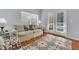 Living room with hardwood floors, french doors and decorative rug at 2203 San Vittorino Cir # 102, Kissimmee, FL 34741