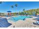 Community pool with lounge chairs, playground, and palm trees at 2203 San Vittorino Cir # 102, Kissimmee, FL 34741