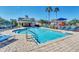 Community pool with lounge chairs, playground, and pool house at 2203 San Vittorino Cir # 102, Kissimmee, FL 34741