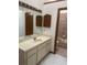 Bathroom featuring a large vanity with a sink, a mirror, and a combination shower and tub at 118 Cedar Rd, Ocala, FL 34472