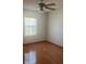 Bedroom featuring neutral walls, hardwood floors, a ceiling fan, and natural lighting at 118 Cedar Rd, Ocala, FL 34472