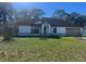 Charming single-story home with well-maintained lawn and attached two-car garage at 118 Cedar Rd, Ocala, FL 34472