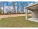 A view of the backyard, showcasing a patio and grassy area, surrounded by trees at 13516 Sw 78 Pl, Dunnellon, FL 34432