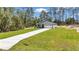 New construction home with a well-manicured lawn, a long driveway and attached two-car garage at 13516 Sw 78 Pl, Dunnellon, FL 34432