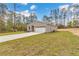 Charming single-story home featuring a spacious lawn and a long driveway leading to an attached garage at 13516 Sw 78 Pl, Dunnellon, FL 34432