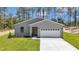Charming single-story home featuring a bright exterior, two-car garage, and neat landscaping at 13516 Sw 78 Pl, Dunnellon, FL 34432