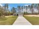 Attractive single-story home with a well-manicured lawn and long driveway, surrounded by tall trees at 13516 Sw 78 Pl, Dunnellon, FL 34432