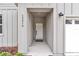 Covered front entry of a home featuring stylish vertical siding, outdoor lighting, and clean lines at 13516 Sw 78 Pl, Dunnellon, FL 34432