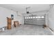 Spacious two car garage with concrete floors and metal garage door, ready for storage and vehicles at 13516 Sw 78 Pl, Dunnellon, FL 34432