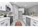 Bright kitchen featuring stainless steel appliances, white cabinets, tile floors and black hardware at 13516 Sw 78 Pl, Dunnellon, FL 34432
