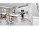 Well-lit kitchen with stainless steel appliances, white cabinets and island with seating at 13516 Sw 78 Pl, Dunnellon, FL 34432