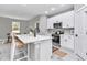Modern kitchen with white cabinets, stainless steel appliances, and central island at 13516 Sw 78 Pl, Dunnellon, FL 34432