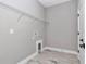 Neat laundry area features a wire shelf, utility connections, and neutral-toned, wood-look tile flooring at 13516 Sw 78 Pl, Dunnellon, FL 34432