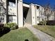 Exterior view of condo building with landscaped grounds and walkway at 171 Springwood Cir # B, Longwood, FL 32750