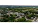 Aerial view of a residential neighborhood surrounded by mature trees and green spaces at 205 E 17Th St, Apopka, FL 32703