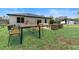 Spacious backyard with a patio, modern outdoor furniture, and lush green grass at 205 E 17Th St, Apopka, FL 32703