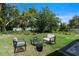Inviting backyard area featuring outdoor seating and a cozy fire pit, perfect for relaxing and entertaining at 205 E 17Th St, Apopka, FL 32703