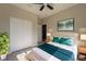 Stylishly staged bedroom offers a comfortable bed, wood-look floors, ceiling fan and ample closet space at 205 E 17Th St, Apopka, FL 32703