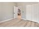 This bedroom offers wood-look floors, a spacious closet, and a doorway to the rest of the house at 205 E 17Th St, Apopka, FL 32703