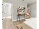 Tastefully designed bedroom featuring elegant art pieces, a comfortable bed, and a hallway leading to a bathroom at 205 E 17Th St, Apopka, FL 32703