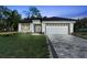 Charming single-story home featuring a clean design, large driveway, and manicured lawn at 205 E 17Th St, Apopka, FL 32703