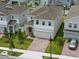 A beautiful neighborhood view shows the home's manicured lawn and brick driveway, and two-car garage at 1162 Happy Forest Loop, Deland, FL 32720