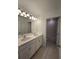 Bathroom with a double vanity, tiled floors, modern lighting and a separated tub and toilet at 1162 Happy Forest Loop, Deland, FL 32720