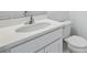 Bathroom featuring white countertops, a modern sink, faucet and white cabinets in a well-lit setting at 1162 Happy Forest Loop, Deland, FL 32720
