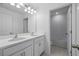 Modern bathroom featuring double sinks, a large mirror and a separate tiled shower/tub area at 1162 Happy Forest Loop, Deland, FL 32720