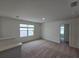 Bedroom featuring neutral carpet, ample natural light, and an open door to another living space at 1162 Happy Forest Loop, Deland, FL 32720