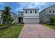 Charming two-story home featuring a brick driveway, an attached two car garage and well-maintained landscaping at 1162 Happy Forest Loop, Deland, FL 32720
