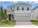 Charming two-story home with a two car garage, landscaped yard and a beautiful brick driveway at 1162 Happy Forest Loop, Deland, FL 32720
