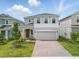 Inviting two-story home with a brick paver driveway and beautiful, green landscaping at 1162 Happy Forest Loop, Deland, FL 32720