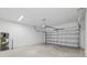 Spacious garage with concrete floor, garage door, utility connections and overhead lighting at 1162 Happy Forest Loop, Deland, FL 32720