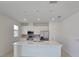 Modern kitchen with white cabinets, stainless steel appliances, a kitchen island and recessed lighting at 1162 Happy Forest Loop, Deland, FL 32720