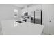 Modern kitchen with stainless steel appliances, white cabinets, and a large countertop island with sink at 1162 Happy Forest Loop, Deland, FL 32720