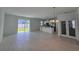 Bright living room with tile floors, stainless steel kitchen appliances, and sliding doors leading to the backyard at 1162 Happy Forest Loop, Deland, FL 32720