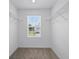 Bright walk-in closet with carpet floors, wire shelves and a window at 1162 Happy Forest Loop, Deland, FL 32720