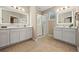 Spacious bathroom with double sinks, a large mirror, and a walk-in shower at 12983 Westside Village Loop, Windermere, FL 34786