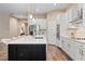 Modern kitchen with white cabinets, large island, and stainless steel appliances at 12983 Westside Village Loop, Windermere, FL 34786