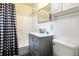 Bathroom featuring a gray vanity with a white countertop and a tiled tub with shower at 1311 Hartley Ave, Deltona, FL 32725