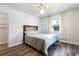 Bedroom with white walls, wood floors, neutral linens and natural lighting at 1311 Hartley Ave, Deltona, FL 32725