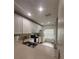 Bright kitchen with white cabinets, a stainless-steel sink and view of the window at 3660 Wilshire Way Rd # 260, Orlando, FL 32829