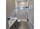 Bathroom featuring a shower with glass door, white subway tile, and black fixtures at 0 Oberly Pkwy, Orlando, FL 32833