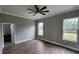 Spacious bedroom featuring wood-look tile flooring, two windows, and an attached bathroom at 0 Oberly Pkwy, Orlando, FL 32833