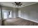 The bedroom features double doors to a patio and wood-look tile flooring, blending comfort with modern elegance at 0 Oberly Pkwy, Orlando, FL 32833