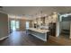 Spacious kitchen featuring an island with pendant lighting and stainless steel appliances and wood-look tile floors at 0 Oberly Pkwy, Orlando, FL 32833