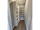 A walk-in pantry features generous shelving for ample storage, and wood-look vinyl flooring that adds warmth and style at 0 Oberly Pkwy, Orlando, FL 32833